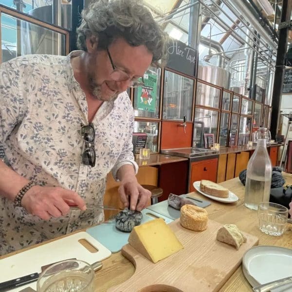 Kaesanova Michael preparing cheese for a tour.