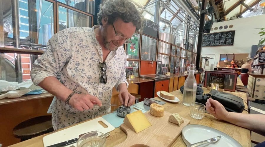 Kaesanova Michael preparing cheese for a tour.