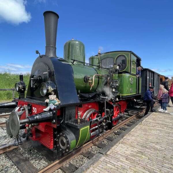 Passengers boarding a heritage steam train on a private day trip through the Dutch countryside