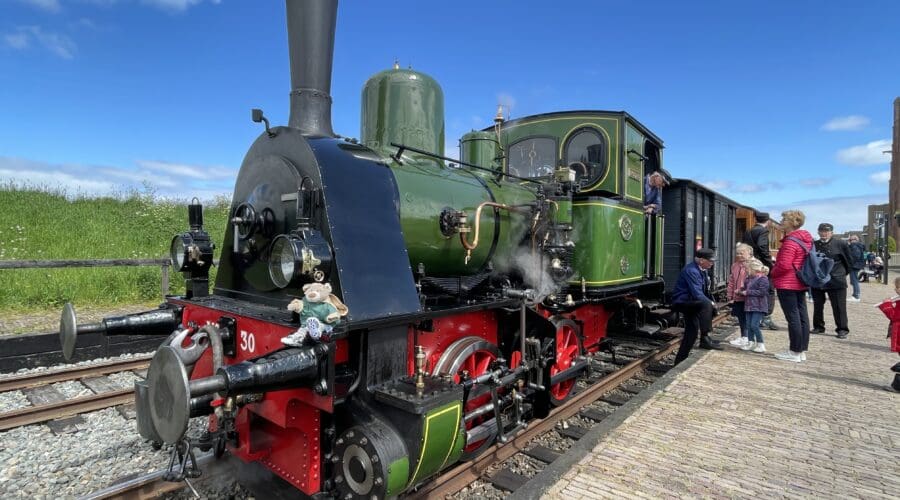 Passengers boarding a heritage steam train on a private day trip through the Dutch countryside