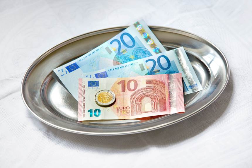 Cash and coins left as a tip on a café table in Amsterdam