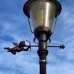 Streetart Frankey's Cupid aiming his bow from an Amsterdam lamppost