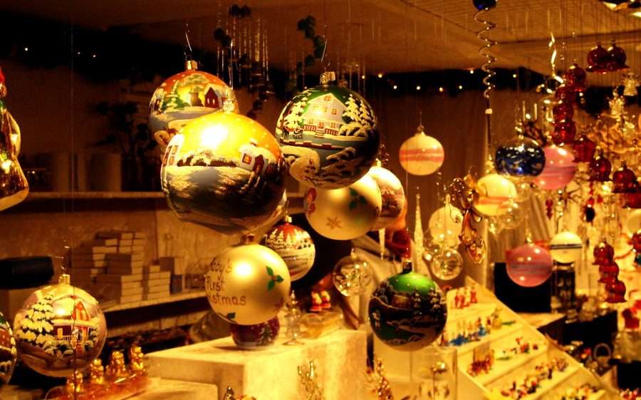 Gold and glass baubles in a lit Christmas market stall