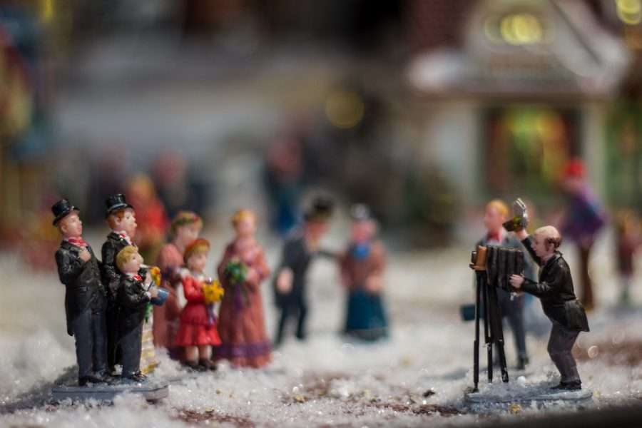 Miniature Victorian figures in a Christmas village display