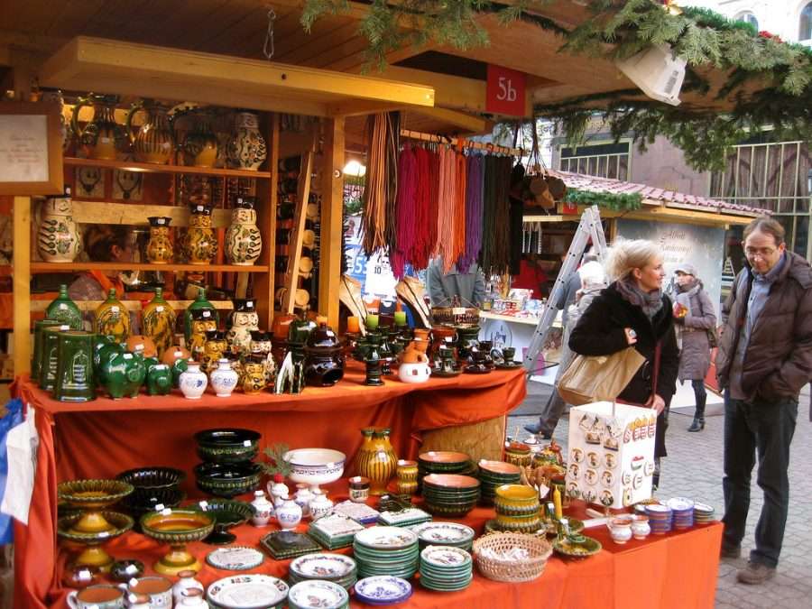 A wooden Christmas market stall with preserves and decorations