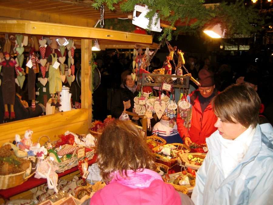 A wooden Christmas market stall hung with decorations